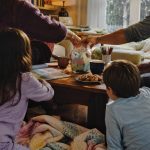A family choosing an activity from a jar together on a cozy rainy afternoon